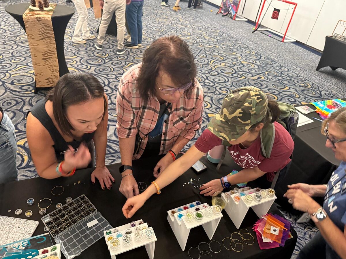 Guests choosing beads and charms at a bracelet making station