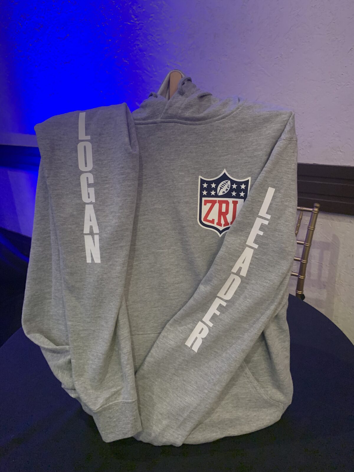 Grey custom hoodie personalized with a name down the sleeve