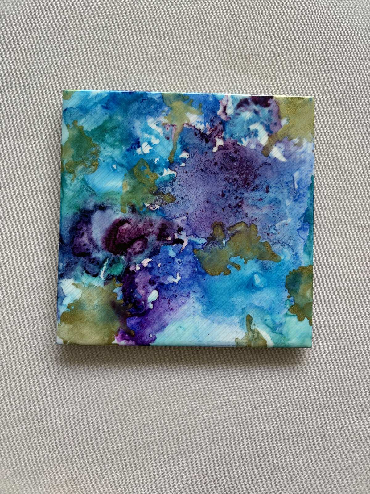 Finished alcohol ink tile artwork in blue and purple