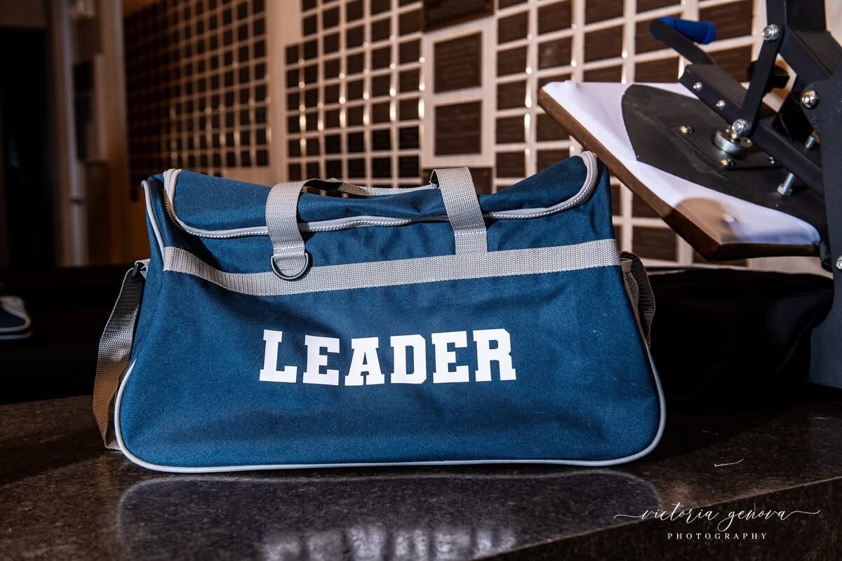 Navy custom duffel bag embroidered with the word Leader