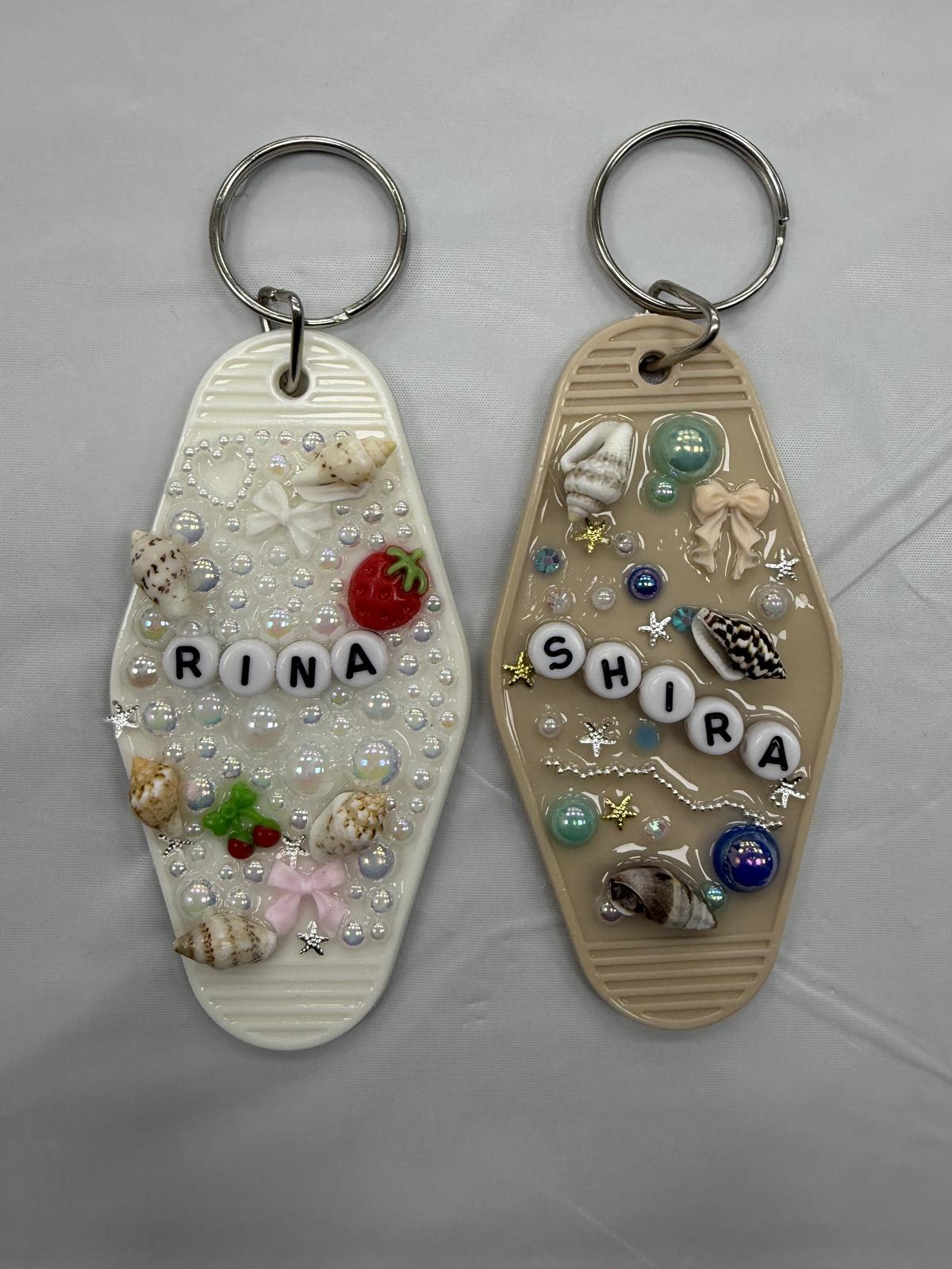 Two resin keychains with pearls, shells and beaded names