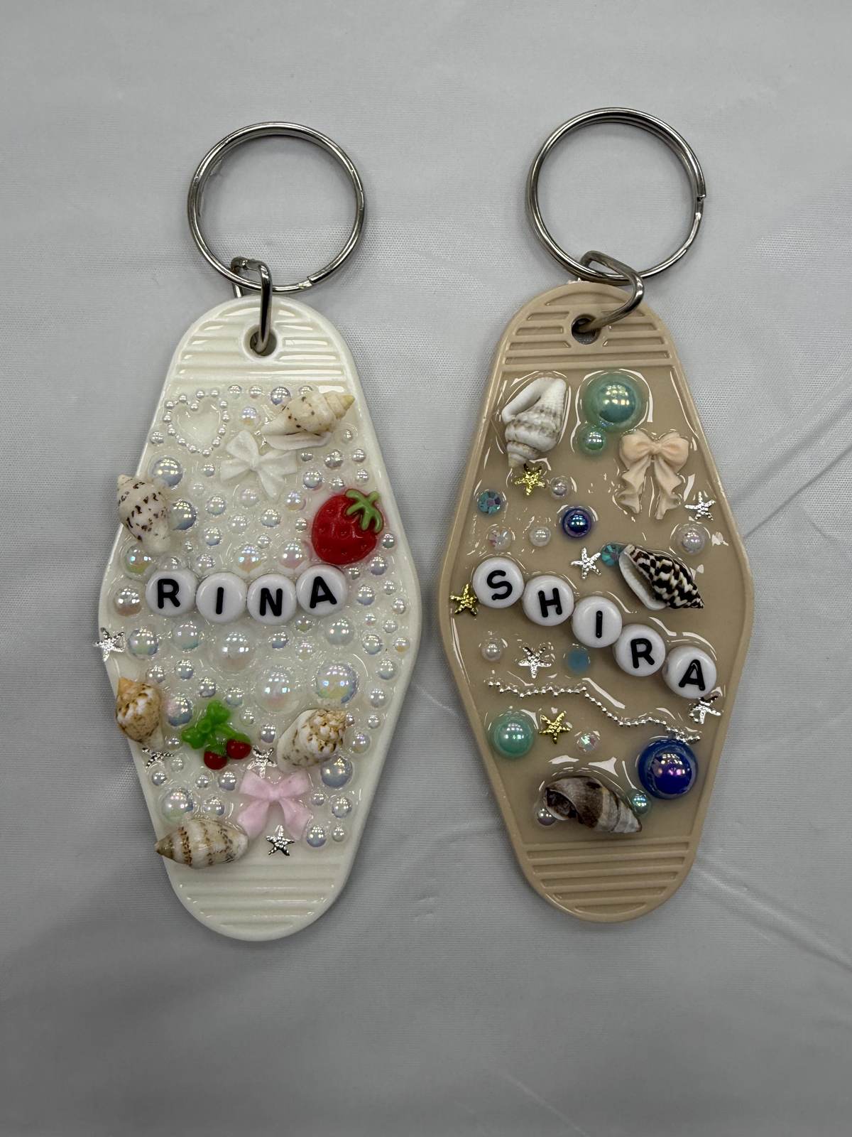Two resin keychains with pearls, shells and beaded names
