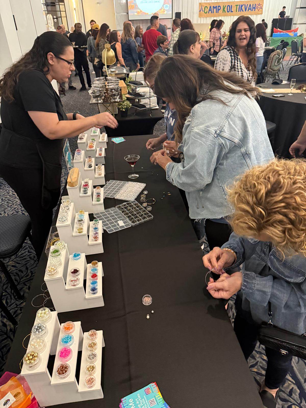 Students gathered around a C By Me craft station at a school community event
