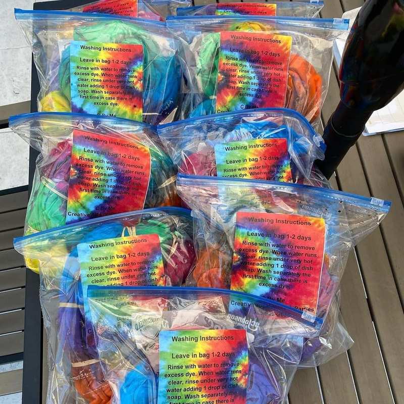 Finished tie dye shirts bagged with washing instructions as party favors
